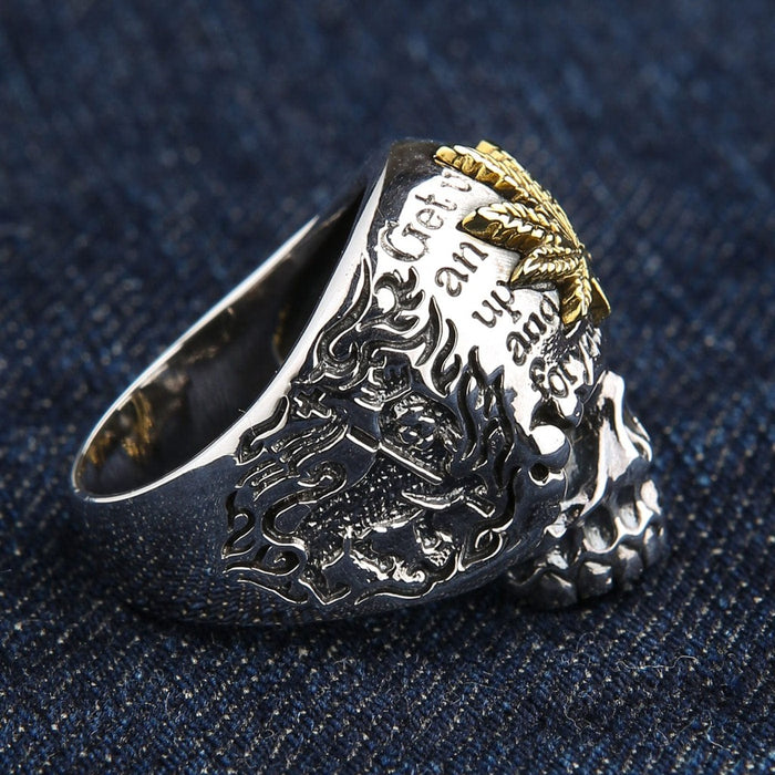 Back side angle of punk skull ring with brass marijuana leaf and engraved message