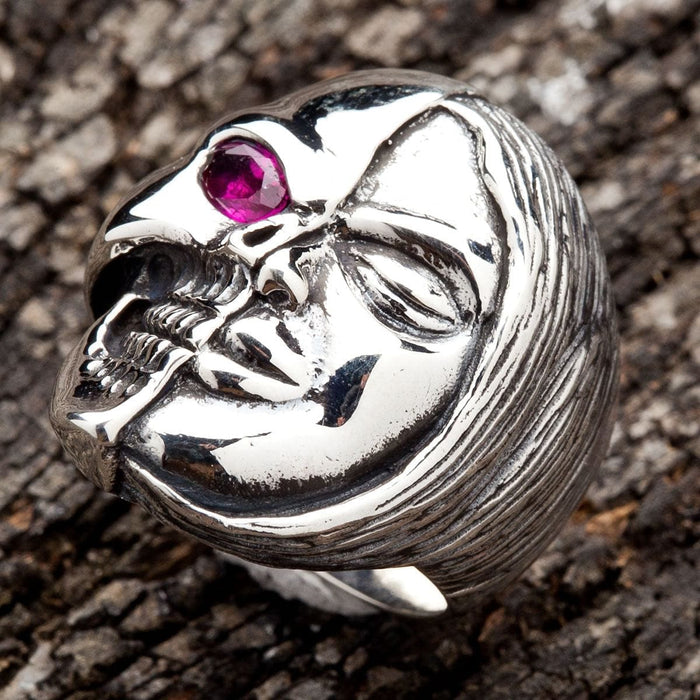 A men's ring symbolizing the duality of life and death, with a split human and skull face.