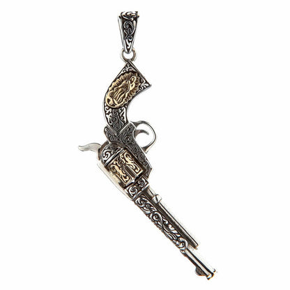 A two-tone Mexican gun pendant, handcrafted from sterling silver with brass accents on the grip and cylinder.