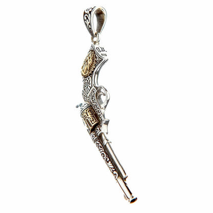 A hand-engraved silver pistol pendant with a detailed, oxidized finish.
