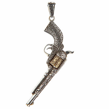 A Western-style gun necklace pendant in a two-tone silver and brass finish.