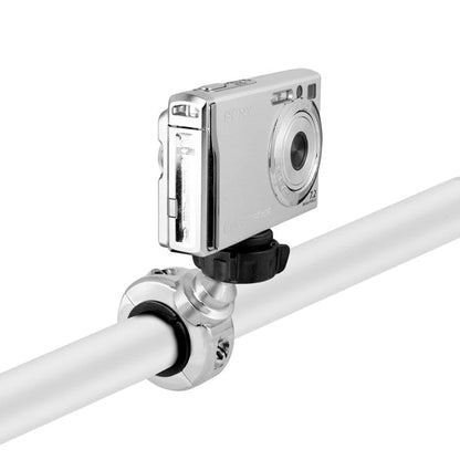 A chrome aluminum Motorcycle Handlebar Camera Mount for Canon, Sony, and Contour action cameras is securely clamped to a white cylindrical pole via a black knob, holding a compact silver digital camera with a 1/4-20 mounting pattern facing forward.