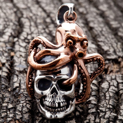 A front view of the two-tone octopus skull pendant, showing the bronze kraken wrapping a sterling silver skull.