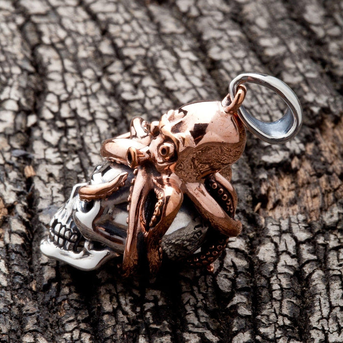A side profile of the men's nautical skull pendant, showing the contrast between silver and bronze.