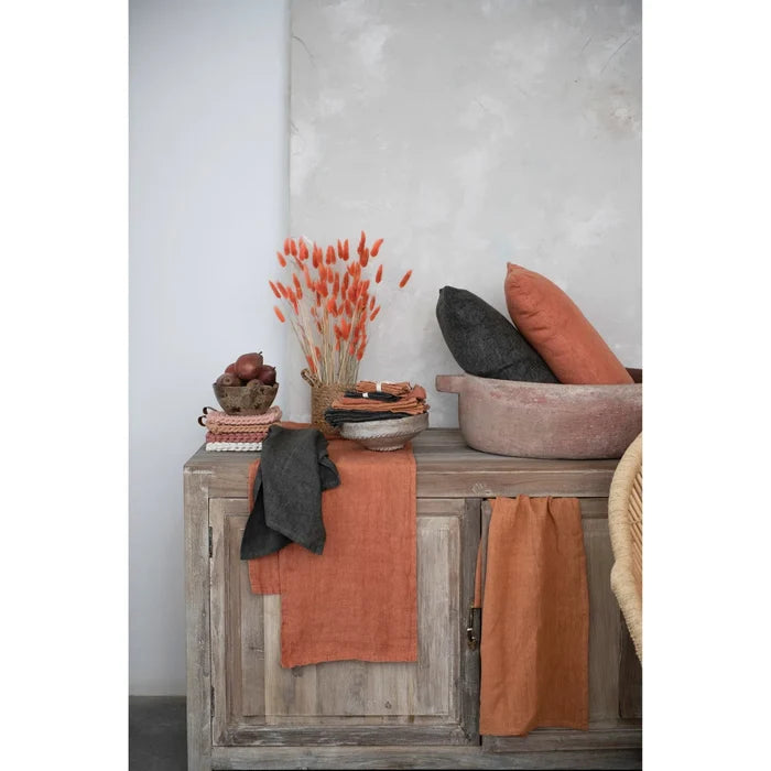 Weathered wooden cabinet with oversized stonewashed linen tea towel and decorative items