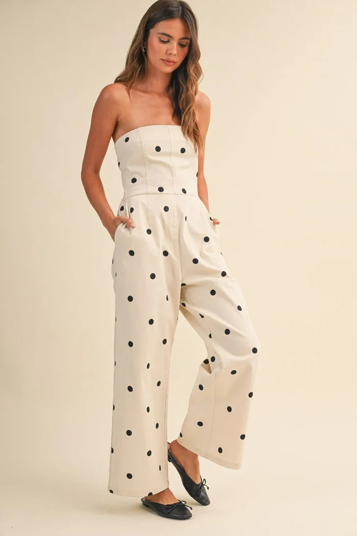 A creamy off-white strapless wide leg jumpsuit with bold black polka dots in stretch twill fabric