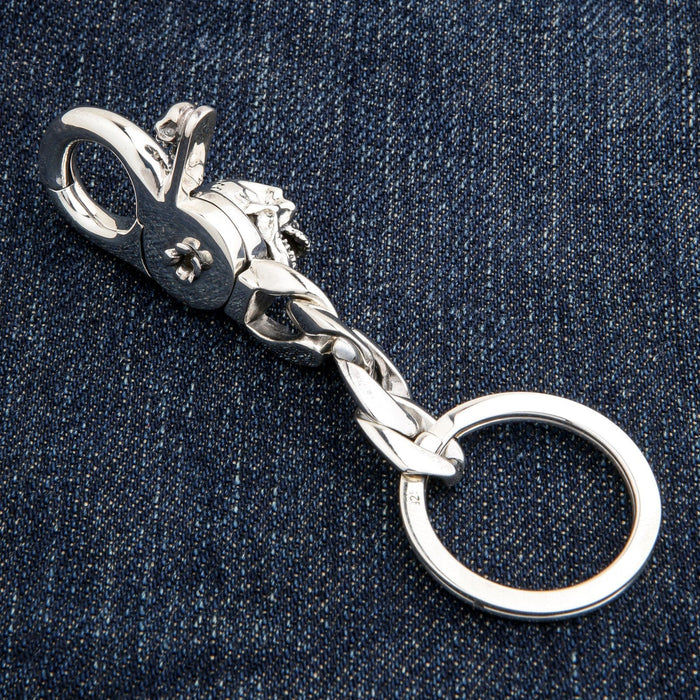 Side profile of handcrafted silver skull keychain mechanism