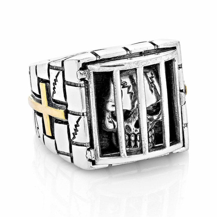 A premium gothic caged skull ring with a hand-carved stone wall band and a brilliant 14K gold cross.