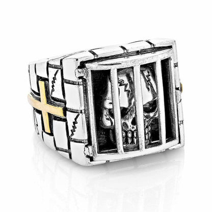 A premium gothic caged skull ring with a hand-carved stone wall band and a brilliant 14K gold cross.