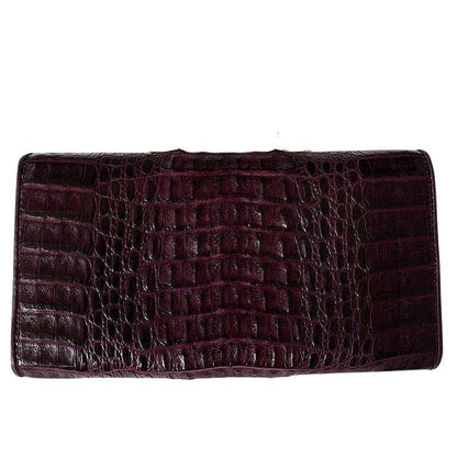 Top-down view of the closed purple crocodile wallet showing smooth scale rows across the body