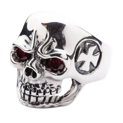 Angled view of a men's gothic skull ring featuring deep red stone eyes and a polished silver finish.