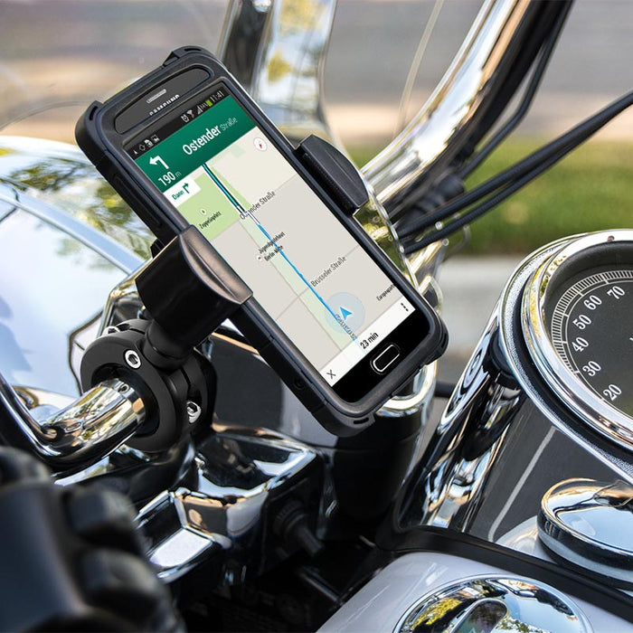 A smartphone with a map app is secured in the black aluminum RoadVise® Motorcycle Phone Mount on the handlebars, with the speedometer and chrome bike details visible in the background.