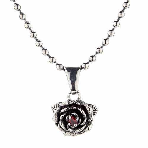 A gothic-style silver rose pendant with a garnet hanging from a sterling silver ball chain.