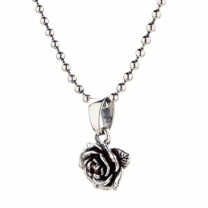 A side view of the silver rose pendant showing the polished bail and the three-dimensional quality of the petals.