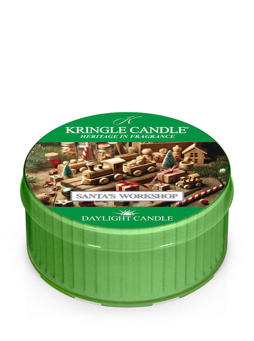 Green daylight of Kringle Candle featuring "Santa's Workshop" design with toys and trees, labeled "Daylight Candle."