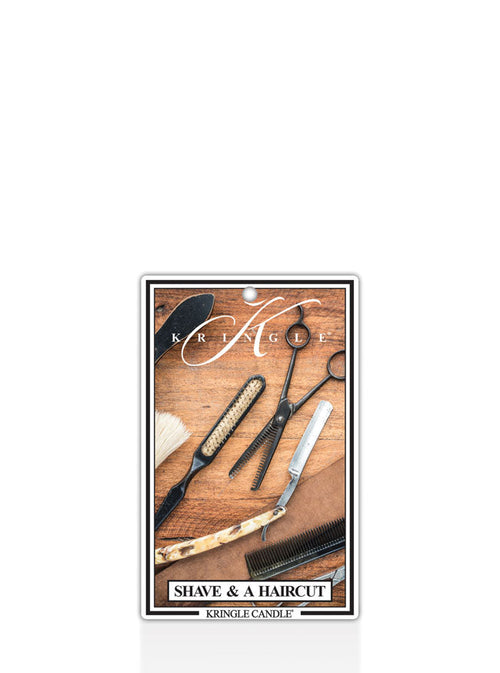 Kringle Candle air freshener with barber tools on a wooden surface label.