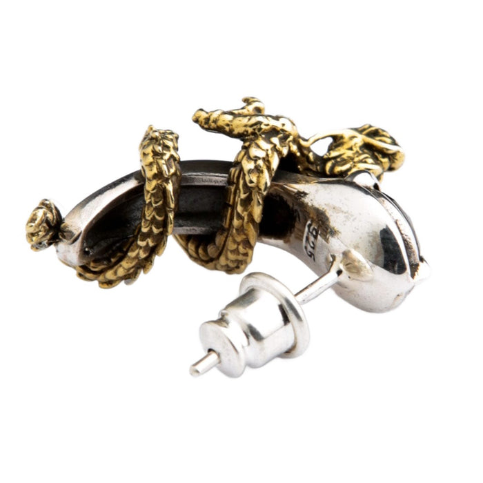 A handcrafted sterling silver dragon earring with the .925 hallmark visible.