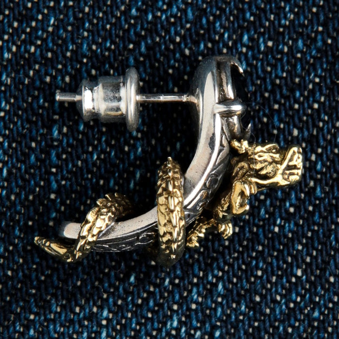 A two-tone dragon earring for men, showcasing the detailed scales of the brass dragon.