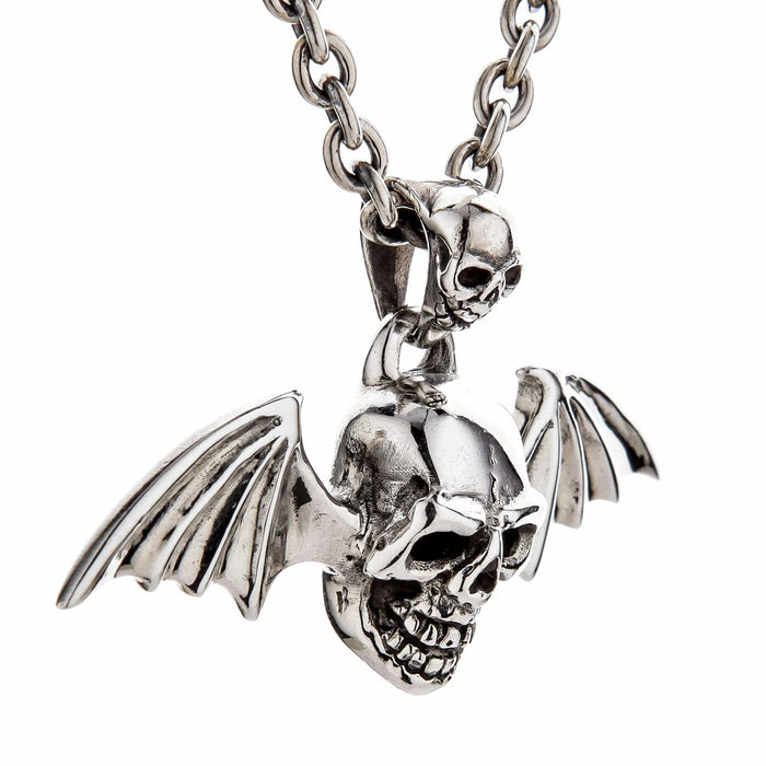 An angled view of the sterling silver skull vampire pendant on a chain, showing the detailed bat wings.