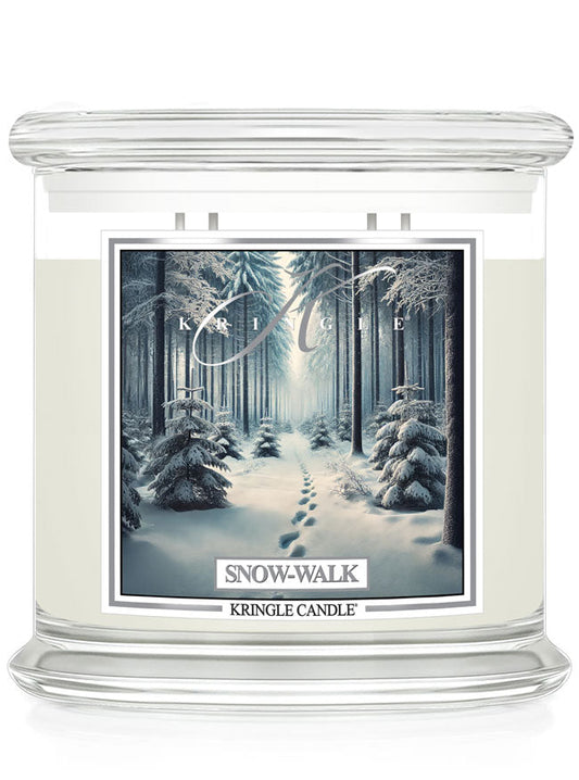 Kringle Candle 4-wick in clear glass with "Snow-Walk" label, featuring a snowy forest path scene.