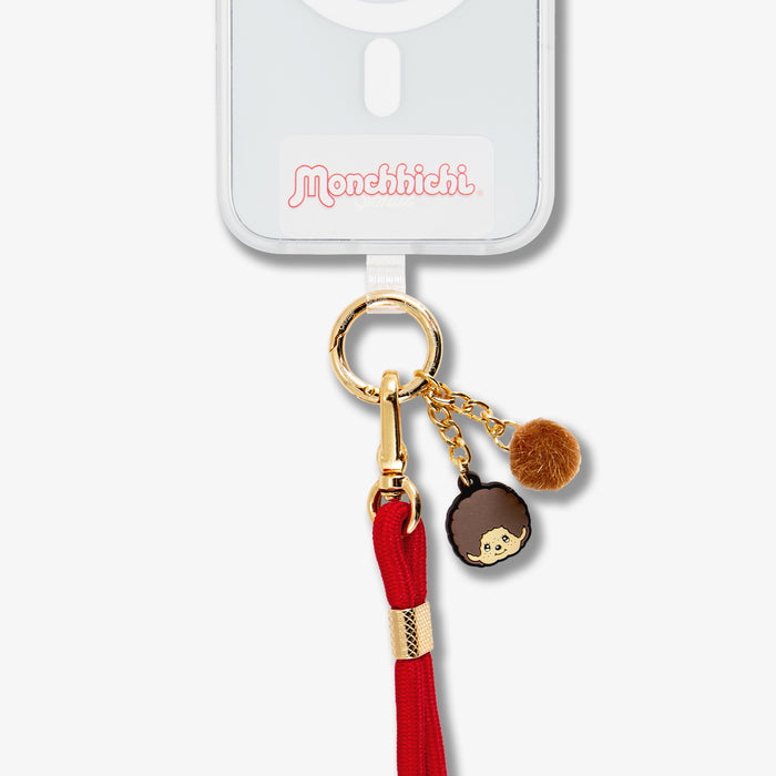 Close-up of crossbody phone strap showcasing gold keyring, character charms and red braided strap on white background