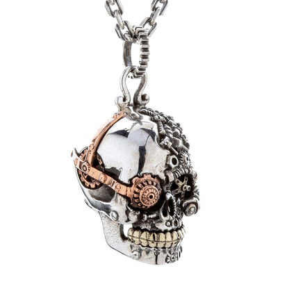 Steampunk skull pendant, focusing on the intricate gear and goggle detail over one eye.
