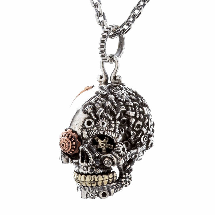 The steampunk skull pendant shown threaded onto a sterling silver chain to form a complete necklace.