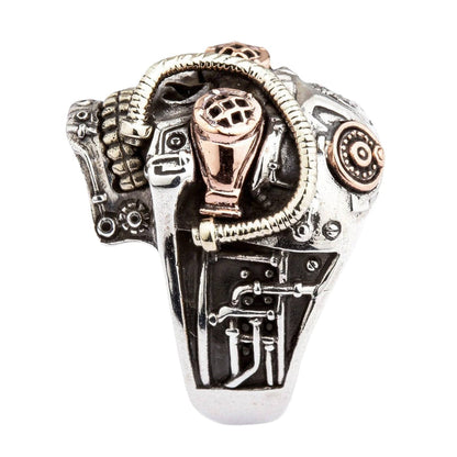 steampunk skull ring, highlighting the detailed pipes and mechanical elements carved into the sterling silver band.