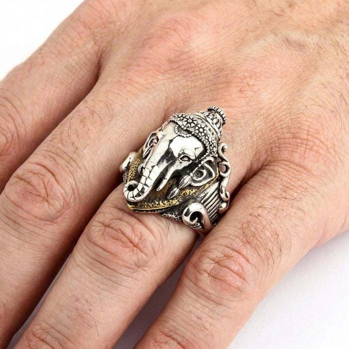 Sterling silver Ganesh Hindu god ring with detailed elephant head design and ornate scrollwork worn on a man's ring finger, showcasing intricate craftsmanship and antique finish