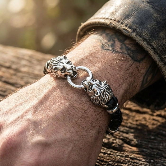 Sterling silver lion head bracelet worn on male wrist with brown leather jacket outdoors