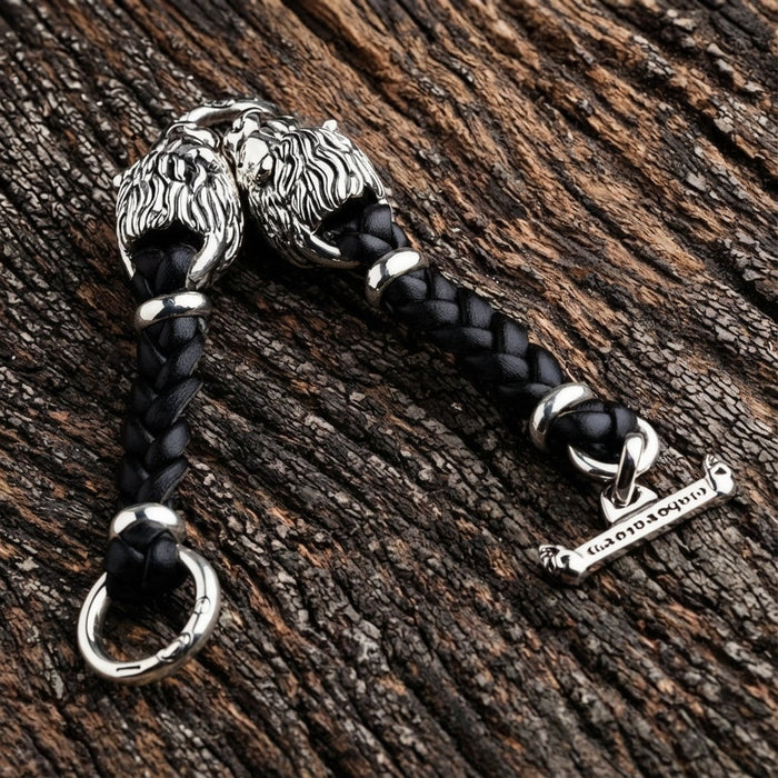 Overhead view of handcrafted sterling silver lion head bracelet with braided black leather band