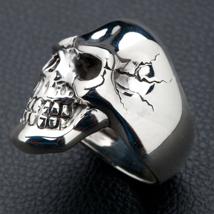 A detailed close-up of the polished sterling silver skull ring, focusing on its flawless surface.