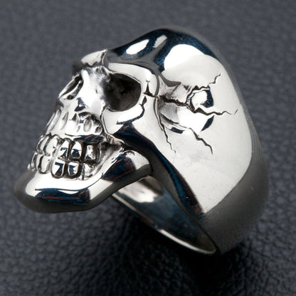 A detailed close-up of the polished sterling silver skull ring, focusing on its flawless surface.
