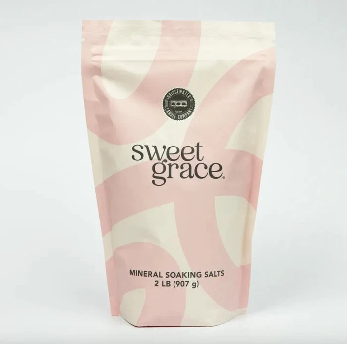 Pink and cream swirl-patterned resealable pouch of sweet grace mineral soaking salts for relaxing sweet grace soaking