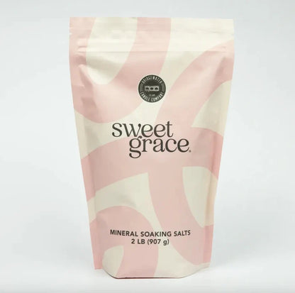 Pink and cream swirl-patterned resealable pouch of sweet grace mineral soaking salts for relaxing sweet grace soaking