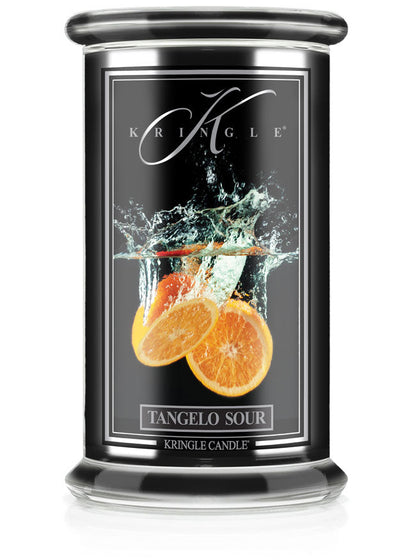 Unlit candle in a black jar labeled "Tangelo Sour" with an image of orange slices splashing in water.