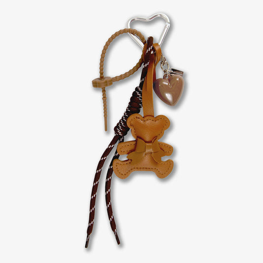 Close-up of Brown Teddy keychain with PU leather teddy, heart charm, braided paracord straps and silver carabiner on white
