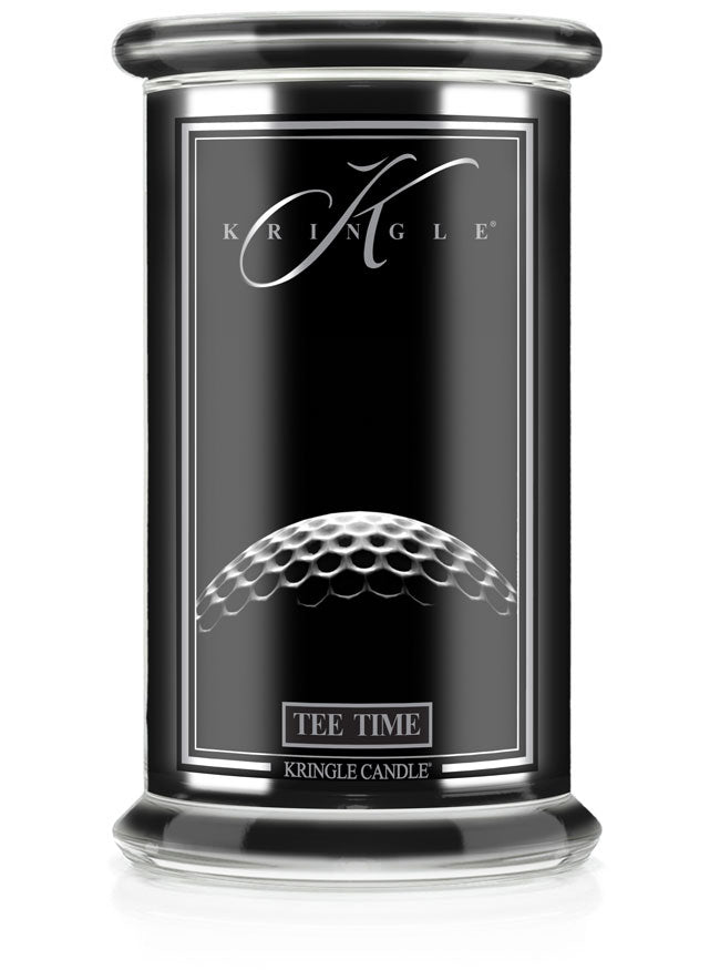 Unlit Reserve candle in "Tee Time" fragrance. Label shows a close-up of a golf ball texture on a sleek black jar.