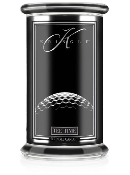 Unlit Reserve candle in "Tee Time" fragrance. Label shows a close-up of a golf ball texture on a sleek black jar.