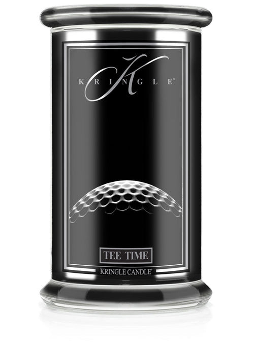 Unlit Reserve candle in "Tee Time" fragrance. Label shows a close-up of a golf ball texture on a sleek black jar.