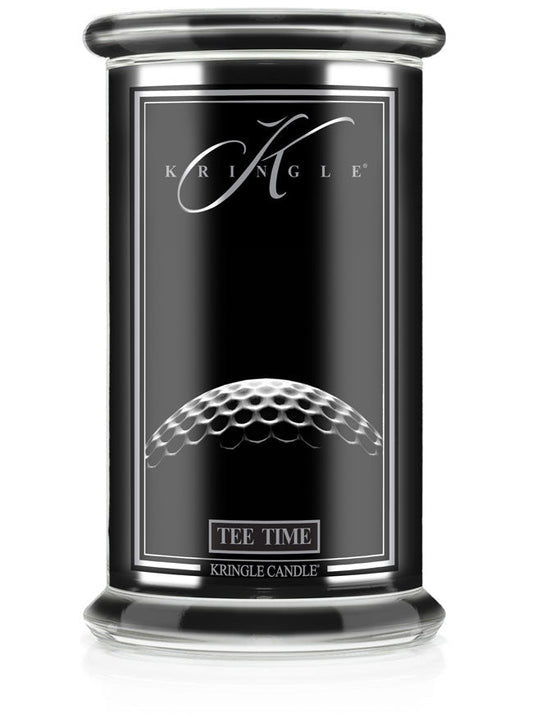 Unlit Reserve candle in "Tee Time" fragrance. Label shows a close-up of a golf ball texture on a sleek black jar.