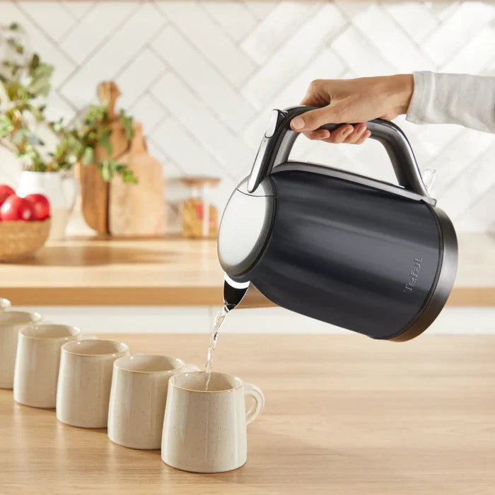 Tefal Subito Black Stainless Steel Toaster & Kettle Breakfast Set with toast in toaster in use pouring boiling water
