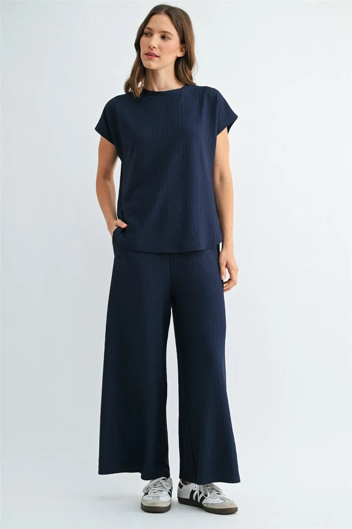 Navy blue textured knit dolman top with short sleeves round neckline and side pockets in ribbed fabric