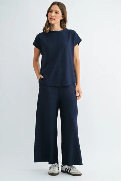 Navy blue textured knit dolman top with short sleeves round neckline and side pockets in ribbed fabric