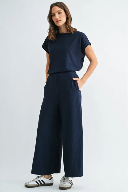 Navy blue textured knit wide-leg pants complementing the textured knit dolman top for stylish knit dolman wear