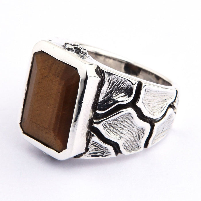 Side angle view of handcrafted Tiger's Eye sterling silver ring showing textured band detail