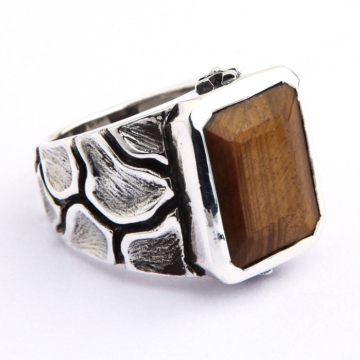 Left side view of men's Tiger's Eye signet ring displaying nature-inspired silver pattern