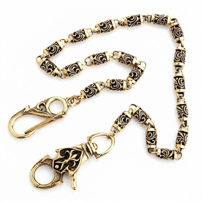 Full 23-inch brass tribal roller chain on white, showing the snap hook and carved lobster claw at both ends.