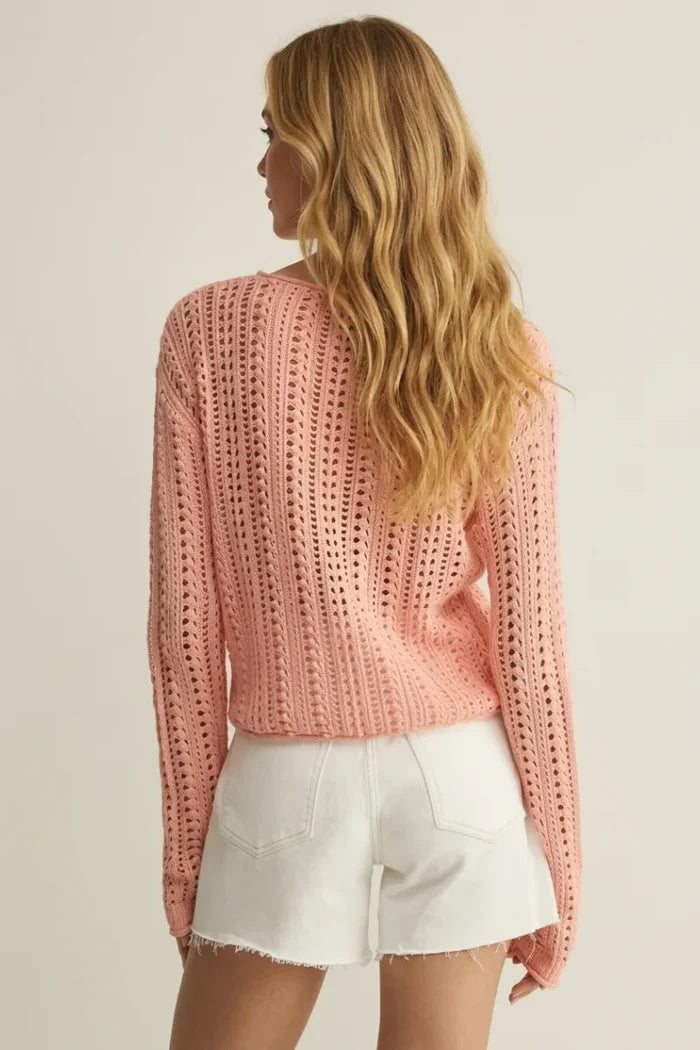 A soft pink upland crochet sweater with long sleeves openwork pattern and ribbed hem knit for comfort