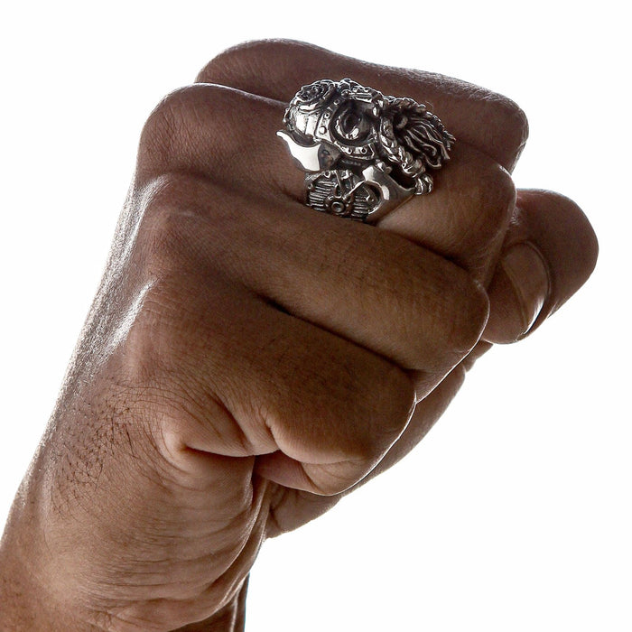 A man's fist wearing the massive Norse warrior ring, showing its bold statement size.